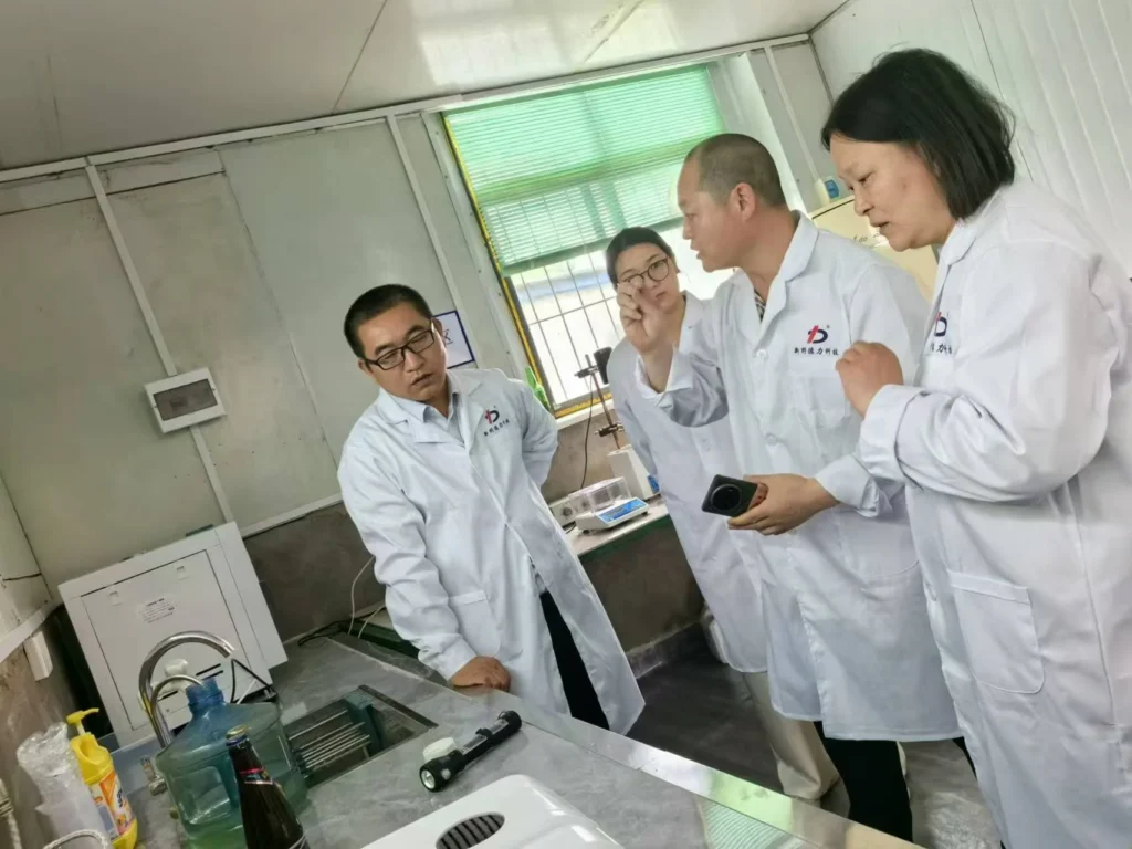 XYDELI laboratory team reviewing a product sample